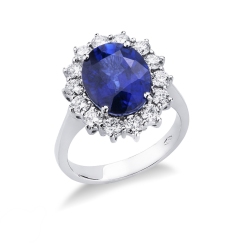 Anillo halo en oro blanco 18k con diamantes y zafiro azul central