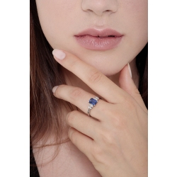 Ring with a blue sapphire emerald cut and four diamonds on each side  2
